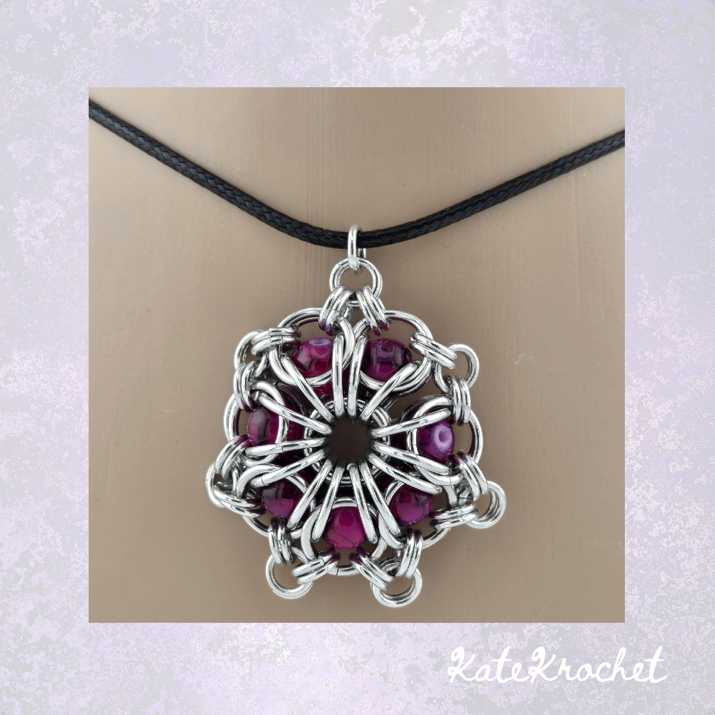 Close up of a Chainmaille Captured Glass Bead Flower Pendant in Crimson by KateKrochet