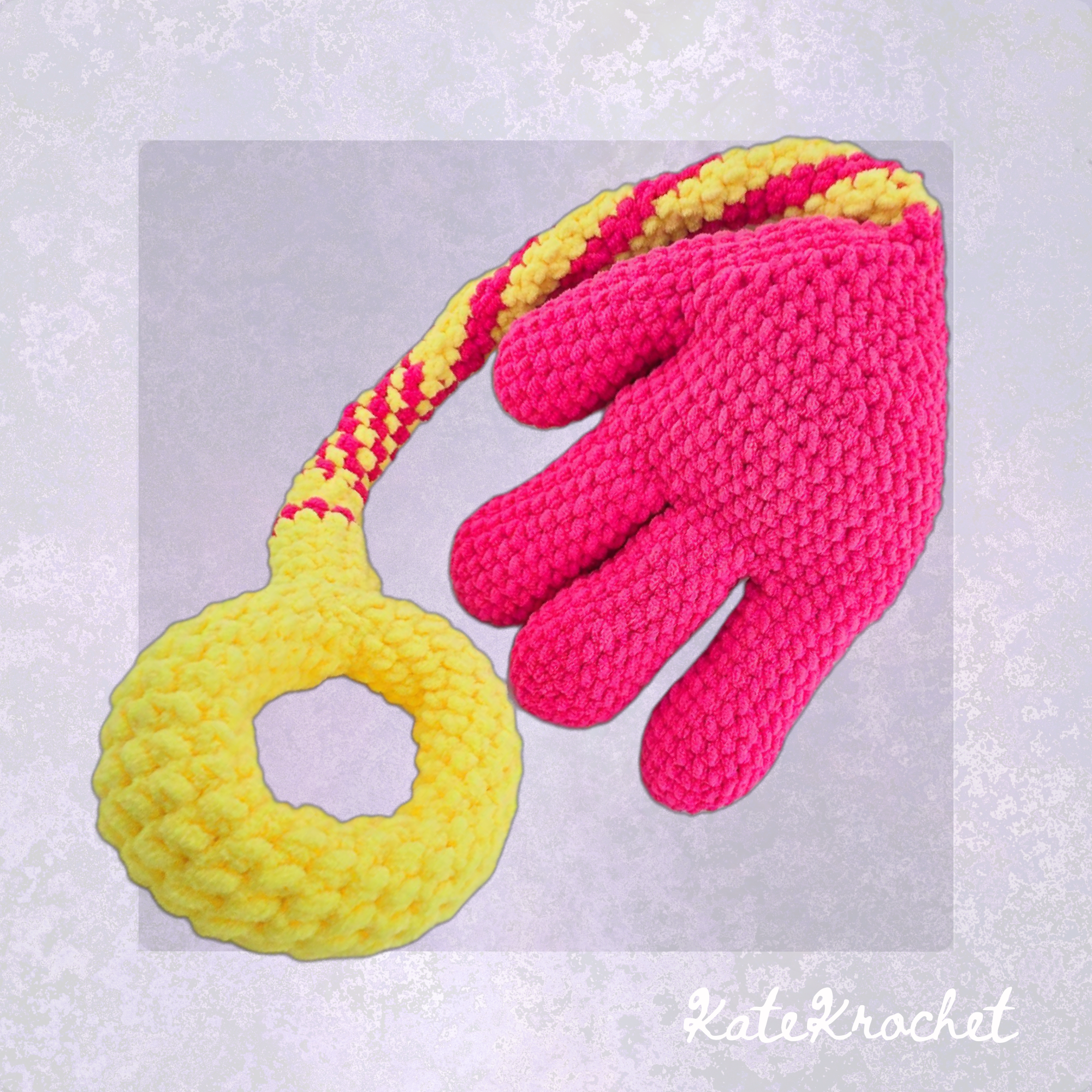 A Handmade Crocheted Giant Slappy Hand in Hot Pink and Bright Yellow Colours made by KateKrochet