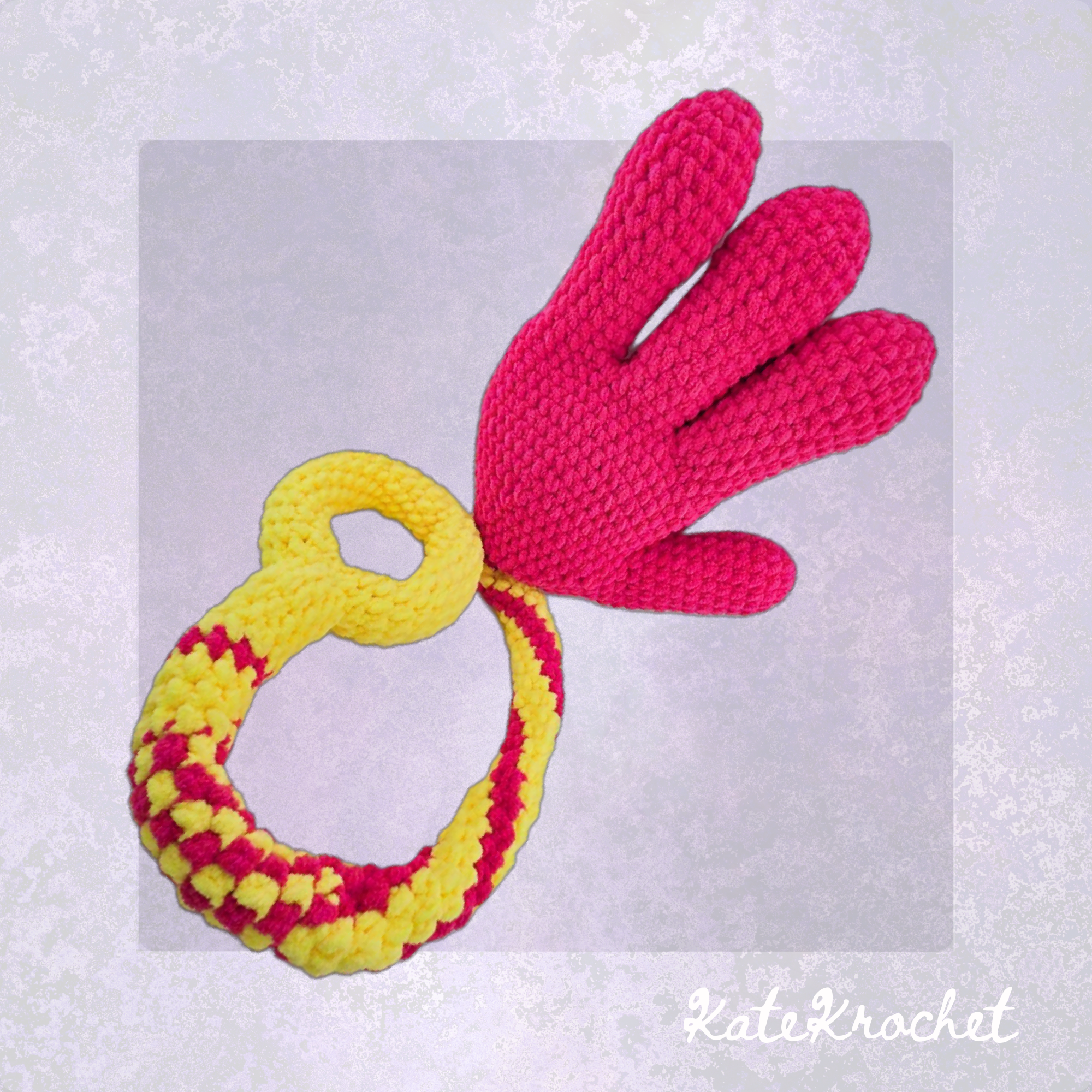 A Handmade Crocheted Giant Slappy Hand in Hot Pink and Bright Yellow Colours made by KateKrochet