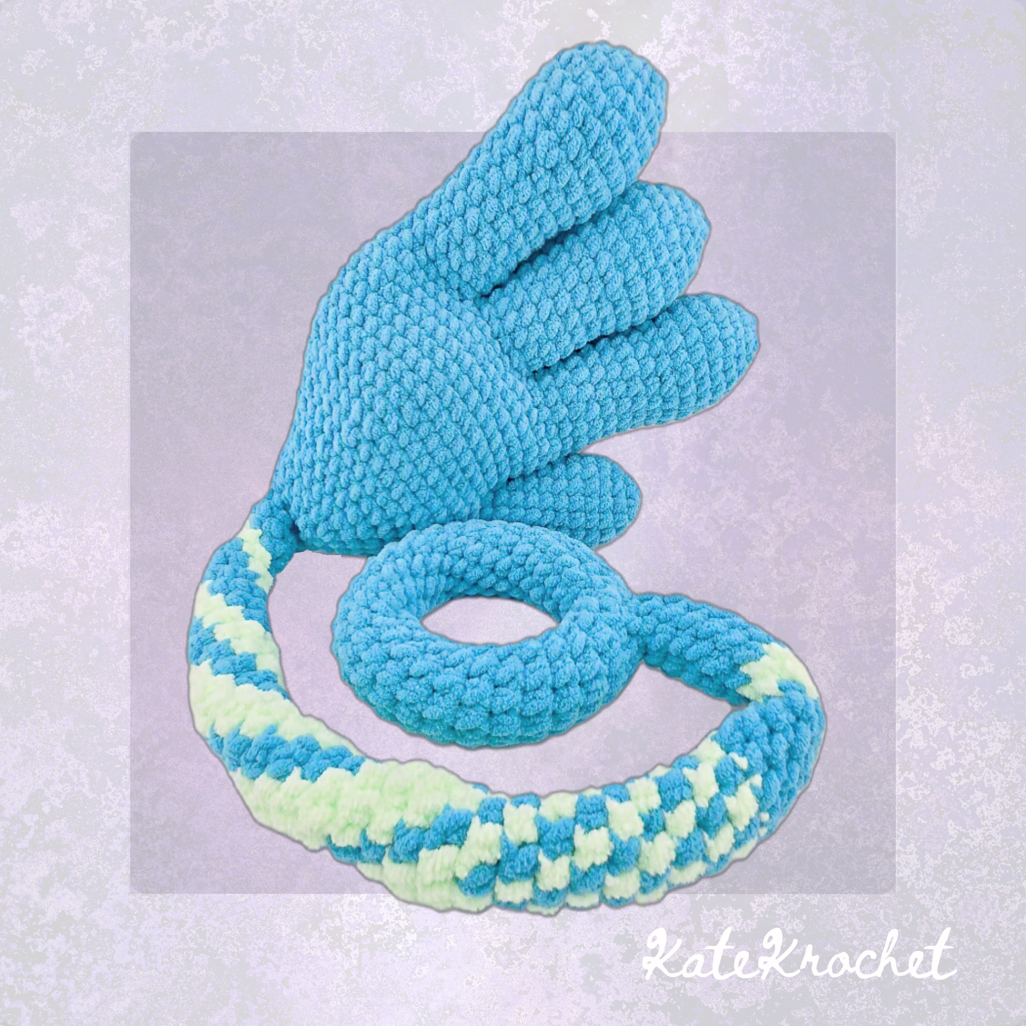 A Handmade Crocheted Giant Slappy Hand in Light Blue and Bright Green Colours made by KateKrochet