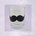 A clear 65ml Shot Glass with a black vinyl moustache made by KateKrochet